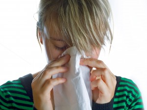 "Woman with allergies sneezing"