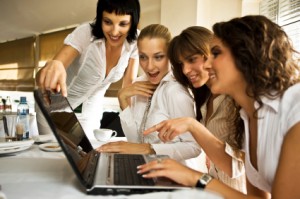 "Women attending an online event on their laptop"
